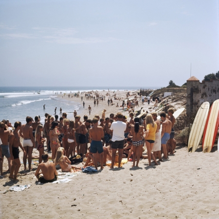 LeRoy Grannis<br /> <em>Watching a Beach Hair Cut, Malibu Surf Rider Beach,</em> 1967<br /> Chromogenic print<br /> 36 x 36"<br /> Edition of 18