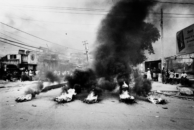 Paolo Pellegrin<br /> <em>Thousands of Preval's supporters take the streets lighting tyres and destroying property in response to alleged voting frauds. Port-au-Prince, Haiti.</em> February 2006<br /> Pigment ink print<br /> 20 x 24” &nbsp; &nbsp;Edition of 10 plus 2 APs<br /> 30 x 40” &nbsp; &nbsp;Edition of 5 plus 2 APs<br /> 48 x 70” &nbsp; &nbsp;Edition of 3 plus 2 APs&nbsp;<br />