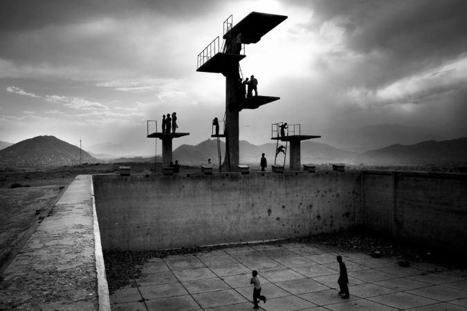 Paolo Pellegrin<br /> <em>Playing football in an empty swimming pool on a hill sorrounding Kabul, Afghanistan. June 2006</em><br /> Pigment ink print<br />20 x 24” &nbsp; &nbsp;Edition of 10 plus 2 APs<br /> 30 x 40” &nbsp; &nbsp;Edition of 5 plus 2 APs<br /> 48 x 70” &nbsp; &nbsp;Edition of 3 plus 2 APs