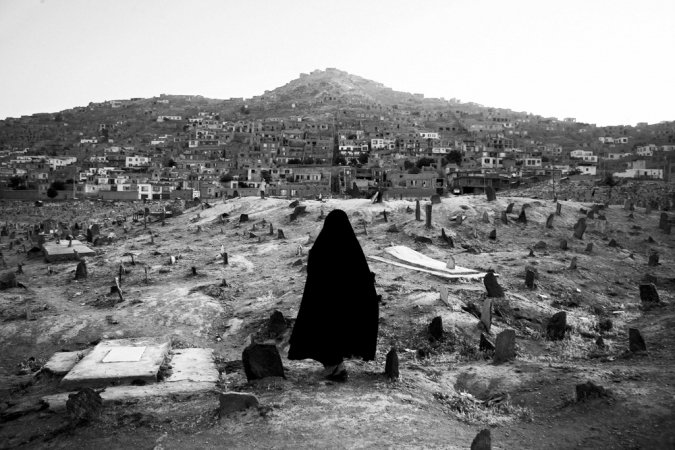 Paolo Pellegrin<br /> <em>At dawn a woman walks though the Ziamate Sakhi cemetary in Kabul, Afghanistan. June 2006</em><br /> Pigment ink print<br />20 x 24” &nbsp; &nbsp;Edition of 10 plus 2 APs<br /> 30 x 40” &nbsp; &nbsp;Edition of 5 plus 2 APs<br /> 48 x 70” &nbsp; &nbsp;Edition of 3 plus 2 APs