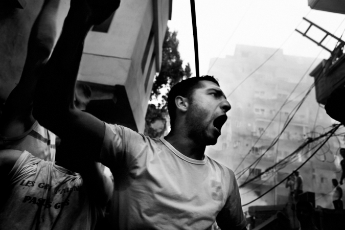 Paolo Pellegrin<br /> <em>An angry crowd gathers moments after Israeli aircraft hit a building in downtown Tyre, Lebanon</em>, 2006<br /> Pigment ink print<br /> 20 x 24” &nbsp; &nbsp;Edition of 10 plus 2 APs<br /> 30 x 40” &nbsp; &nbsp;Edition of 5 plus 2 APs<br /> 48 x 70” &nbsp; &nbsp;Edition of 3 plus 2 APs&nbsp;<br />