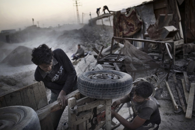Paolo Pellegrin<br /> <em>Gazans fix a donkey cart for collecting mountains of rubble left in 2008-09 by Operation Cast Lead, Gaza, Palestine 2011</em><br /> Pigment ink print<br />20 x 24” &nbsp; &nbsp;Edition of 10 plus 2 APs<br /> 30 x 40” &nbsp; &nbsp;Edition of 5 plus 2 APs<br /> 48 x 70” &nbsp; &nbsp;Edition of 3 plus 2 APs