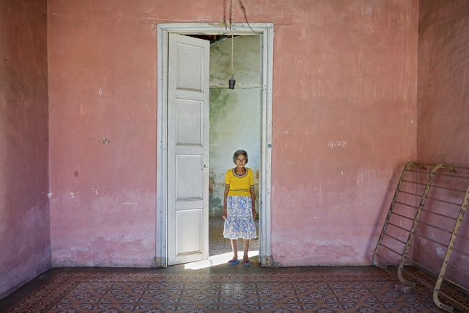 Jeffrey Milstein<br /> <em>Woman in Door, Trinidad, Cuba, </em>2004<br /> Archival pigment prints<br /> 16 x 24" &nbsp; &nbsp;Edition of 15<br /> 22 x 33" &nbsp; &nbsp;Edition of 5