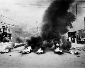 Paolo Pellegrin<br /> <em>Thousands of Preval's supporters take the streets lighting tyres and destroying property in response to alleged voting frauds. Port-au-Prince, Haiti.</em> February 2006<br /> Pigment ink print<br /> 20 x 24” &nbsp; &nbsp;Edition of 10 plus 2 APs<br /> 30 x 40” &nbsp; &nbsp;Edition of 5 plus 2 APs<br /> 48 x 70” &nbsp; &nbsp;Edition of 3 plus 2 APs&nbsp;<br />