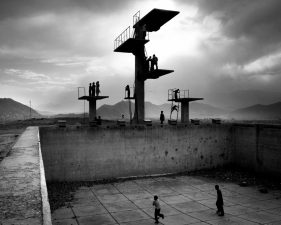 Paolo Pellegrin<br /> <em>Playing football in an empty swimming pool on a hill sorrounding Kabul, Afghanistan. June 2006</em><br /> Pigment ink print<br />20 x 24” &nbsp; &nbsp;Edition of 10 plus 2 APs<br /> 30 x 40” &nbsp; &nbsp;Edition of 5 plus 2 APs<br /> 48 x 70” &nbsp; &nbsp;Edition of 3 plus 2 APs